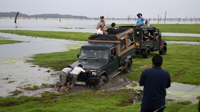 Liam Dawson, Ben Stokes, Olly Stone, Chris Woakes and Jonathan Bairstow of England's truck get stuck in the mud as they take part in an elephant safari at Kaudulla National Park in Dambulla. Getty Images