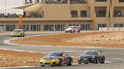 The PorscheGT3 cars thunder around the Reem International Circuit.