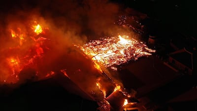 Smoke and flames rise from burning Shuri Castle in Naha, Okinawa. Kyodo News via AP