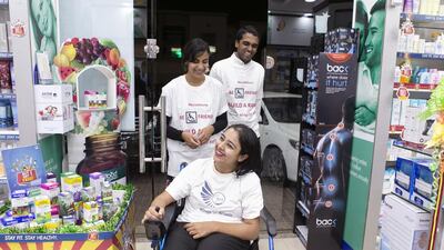 Shobhika Kalra, at Aster Pharmacy where she campaigned to install a ramp, next to her home. With her is Ruchika, her sister, and Reuben Samuel, a volunteer with Wings of Angelz. Reem Mohammed