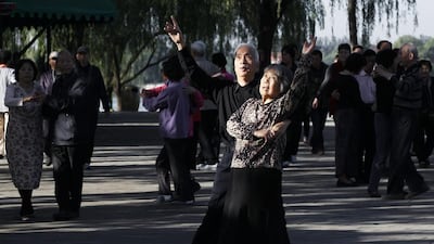 Chinese couples dance at an open space of the Summer Palace in Beijing. Rolex Dela Pena / EPA