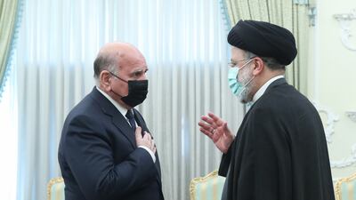 Iranian President Ebrahim Raisi, right, greets Iraqi Foreign Minister Fuad Hussein in Tehran. EPA