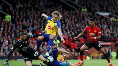 Southampton's Angus Gunn, Jannik Vestergaard and Maya Yoshida in action with Manchester United's Marcus Rashford. Action Images via Reuters
