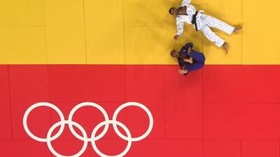 Antoine Bouchard of Canada and Masashi Ebinuma of Japan (blue) lay on the mats during the men’s 66kg bronze medal B final.(Photo by Richard Heathcote/Getty Images)