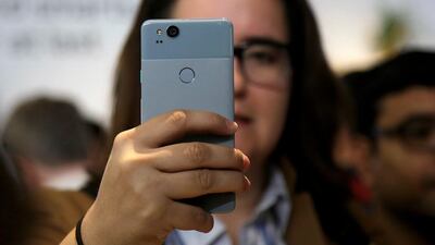 A woman looks at a Google Pixel 2 phone at a Google event at the SFJAZZ Center in San Francisco. Jeff Chiu / AP Photo