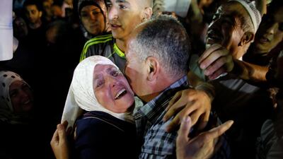 Freed Palestinian prisoner Jamil Nabi Annatsheh is greeted by his mother upon his arrival in the West Bank city of Ramallah. REUTERS / Ammar Awad