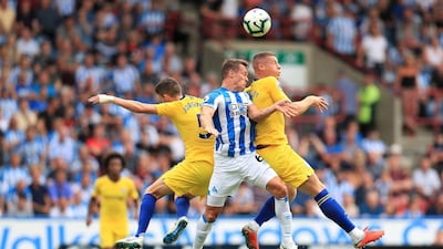 Huddersfield Town's Jonathan Hogg, centre, battles with Chelsea's Jorginho, left, and Ross Barkley. PA / AP