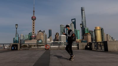 A man walks on the Bound with Pudong main financial district in background, in Shanghai. EPA