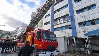 Tunisian firefighters put out a blaze at the Islamist party Ennahda's headquarters in Tunis on December 9. AFP