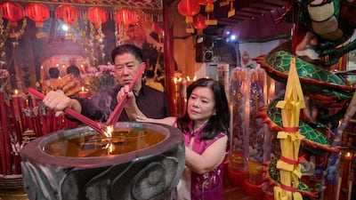 People burn incense sticks as they offer prayers on the first day of the Lunar New Year at Hong San Koo Tee temple in Surabaya, Indonesia. AFP