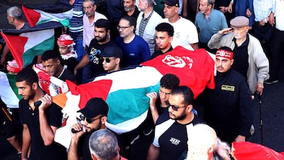 A man salutes as the body of Japanese militant Kozo Okamoto is carried through Beirut. AFP