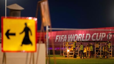 Labourers work to build a structure along a street in Doha. AFP