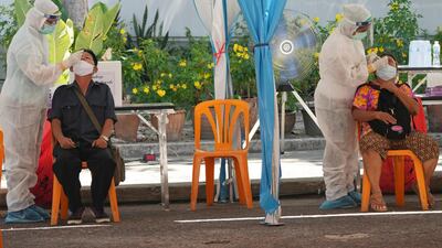 Health workers test residents for the coronavirus in Bangkok, Thailand. AP Photo