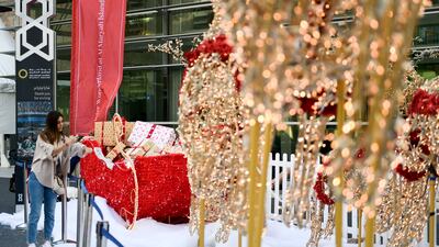 Adding the final touches to Santa's sleigh, outside The Galleria Mall. Khushnum Bhandari / The National