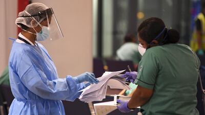 A member of an Indian medical team registers upon her arrival at Dubai International Airport to help with the coronavirus (COVID-19) pandemic. AFP