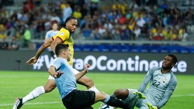 Ecuador's Alexander Dominguez, right, and Uruguay's Luis Suarez, compete for the ball during a Copa America Group C soccer match at the Mineirao stadium in Belo Horizonte, Brazil. AP