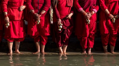 Nepalese Hindu women wait to collect holy water at the Madhav Narayan festival at Sali Nadi in Sankhu, Kathmandu. EPA