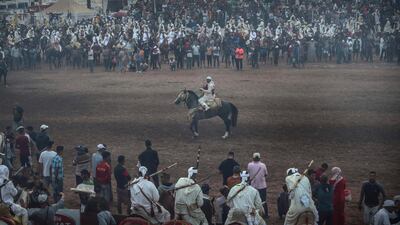 People watch as a rider takes part in Tabourida, a traditional horse riding show also known as Fantasia, in the coastal town of El Jadida, Morocco.