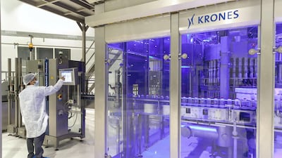 Freshly-made bottles spin behind glass doors at the Mai Dubai factory. The company plans to add a new line that will produce 85,000 bottles per hour, equating to 20 bottles per second. Antonie Robertson/The National