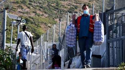 The transfer of migrants to the new site began on Monday. AP