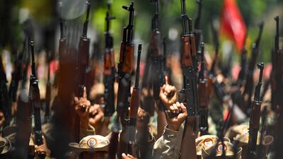 Members of the Venezuelan National Bolivarian Militia, a branch of the National Armed Forces created by the late president Hugo Chavez, celebrate the militia´s 13th anniversary, in Caracas, Venezuela. Government supporters are also commemorating the 20th anniversary of Chavez's return to power after a failed coup in 2002. AP