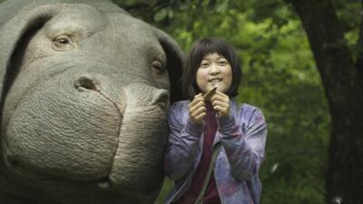 Ahn Seo-hyun as Mija with her gigantic pet and best friend in director Bong Joon-ho’s film Okja – the film attracted attention during its premiere in Cannes in May for all the wrong reasons. Netflix via AP Photo
