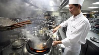 The executive chef Chan Yiu So in his element, creating the luxurious dishes that Abu Dhabi's Shang Palace restaurant is famous for.