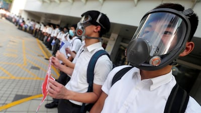 Secondary school students wearing masks join a human chain protesting against what they say is police brutality against protesters, after clashes at Wan Chai district in Hong Kong, China September 9, 2019. Reuters