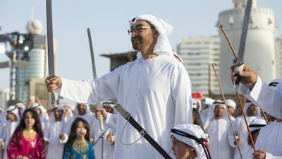 Sheikh Mohammed bin Zayed dances inside the grounds of Qasr Al Hosn fort. Seen with Sheikh Tahnoon bin Mohammed bin Tahnoon Al Nahyan. Ryan Carter / Crown Prince Court - Abu Dhabi