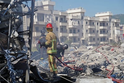 Emergency workers work at the site of an Israeli strike on Habbouch, in southern Lebanon. AFP