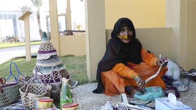 A woman makes traditional woven handicrafts. Sarah Dea / The National