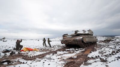 Israeli armored corps soldiers, fix their tank chains during snowstorm near the Israel-Syrian border in the annexed Golan Heights, near the Druze village of Majdal Shams. EPA