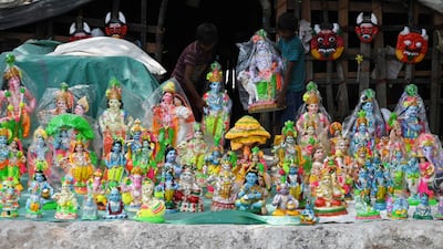 Boys carry an idol of Krishna at a workshop in Chennai. AFP