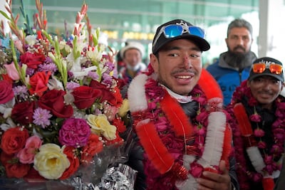 (FILES) Nepal's climber Nirmal Purja (C) watches upon his arrival along with his team at the airport after becoming the firsts to summit Pakistan's K2 mountain in winter, in Islamabad on January 21, 2021. Renowned climber Nirmal Purja was among 10 missing after an avalanche in northern Pakistan where they were on a climbing expedition, the country's alpine club said on July 31, 2026. (Photo by Farooq NAEEM / AFP)