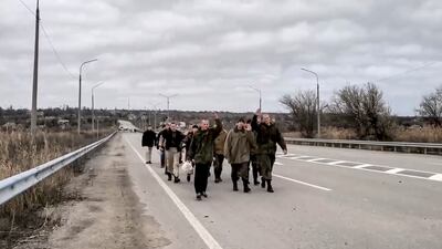 A group of Russian prisoners of war (POW) walk home after a prisoners swap with Ukraine. Russian Defence Ministry Press Service / EPA