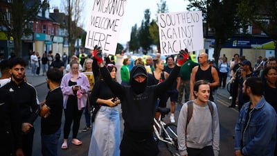 People attend a counter demonstration against an anti-immigration protest called by far-right activists in Westcliff, near Southend-on-Sea. AFP