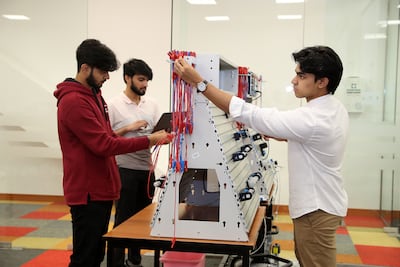 From left, Prateek Mishra, Denver Dias and Zahab Khan at work in the lab at Canadian University Dubai. Pawan Singh / The National