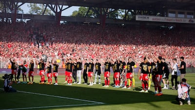 Union Berlin players and fans celebrate after qualifying for the Champions League. Getty