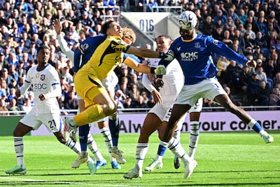 Chelsea goalkeeper Emi Martinez and Everton's Jarrad Branthwaite clash heads. AFP