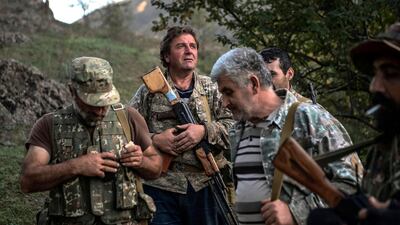 Volunteer fighters stand in a village south-east of Stepanakert during the ongoing fighting between Armenian and Azerbaijani forces. AFP