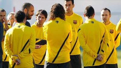 Barcelona's coach Pep Guardiola, fourth left, speaks to his players during a practice session for their upcoming Club World Cup football match against Qatar's Al Sadd in Yokohama.