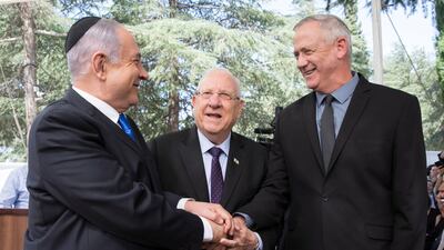 Israeli Prime Minister Benjamin Netanyahu (L), Israeli President Reuven Rivlin (C) and Benny Gantz (R) join hands at a memorial service for late Israeli president Shimon Peres in Jerusalem, on September 19, 2019. EPA