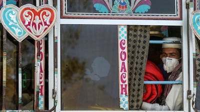 A passenger sits in a bus in Karachi on March 11, 2020. AFP