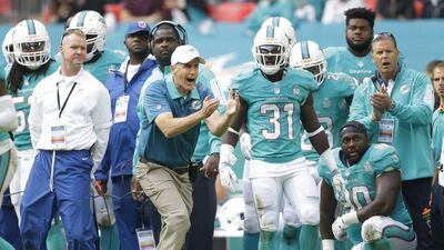 Miami Dolphins coach Joe Philbin, centre, shouts out during the NFL football game between the New York Jets and the Miami Dolphins and at Wembley stadium in London, Sunday, Oct. 4, 2015. (AP Photo/Matt Dunham)