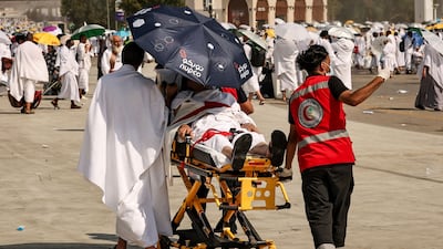 Paramedics evacuate a pilgrim suffering from heat exhaustion at the base of Mount Arafat. AFP