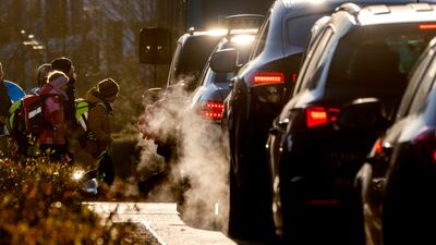 Cars emit exhaust fumes as children head to school in Frankfurt, Germany. AP