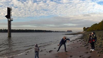 Syrian refugees Wael Al Awis, 31, centre, and his son Ali Al Awis, 6, throw stones into the Elbe river while taking a stroll along the shore near the harbour. Wael arrived in Germany on his own eight months ago and lived for the first five months in a shelter for migrants in Hamburg’s Wilhelmsburg island district. German authorities initially sought to deport him to Spain after they found out that was where he first entered the European Union. Astrid Riecken / Getty Images