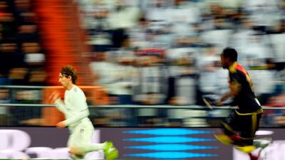 Luka Modric runs with the ball during Real Madrid's match against Rayo Vallecano. AFP