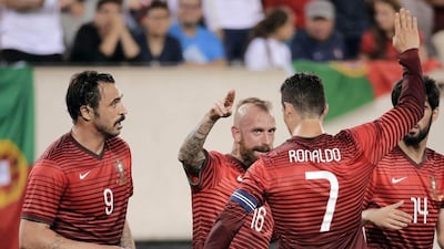 Portugal's Raul Meireles, centre, and Cristiano Ronaldo celebrate with Hugo Almeida, left, after his goal against Ireland in Tuesday night's international friendly ahead of the 2014 World Cup. Ray Stubblebine / Reuters /June 10, 2014