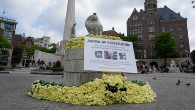 About 4,000 roses and a sign reading 'Attack on the Freedom of Press' lie in Amsterdam after shooting of Peter R de Vries. AP